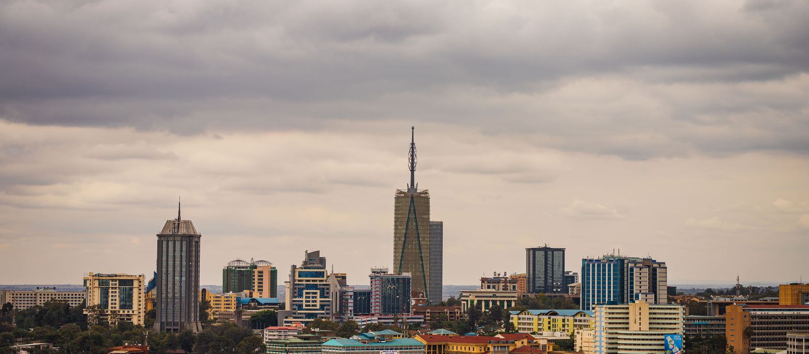 Explore the vibrant skyline of Nairobi with its modern skyscrapers under an overcast sky. — flights from Dar Es Salaam to Nairobi