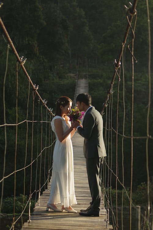 Bride and Groom Standing on the Bridge 
