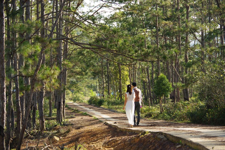 Young Couple Walking In The Forest 