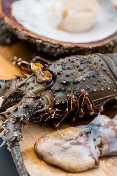 A detailed close-up of fresh  crustacean seafood displayed on a wooden board, perfect for culinary art.