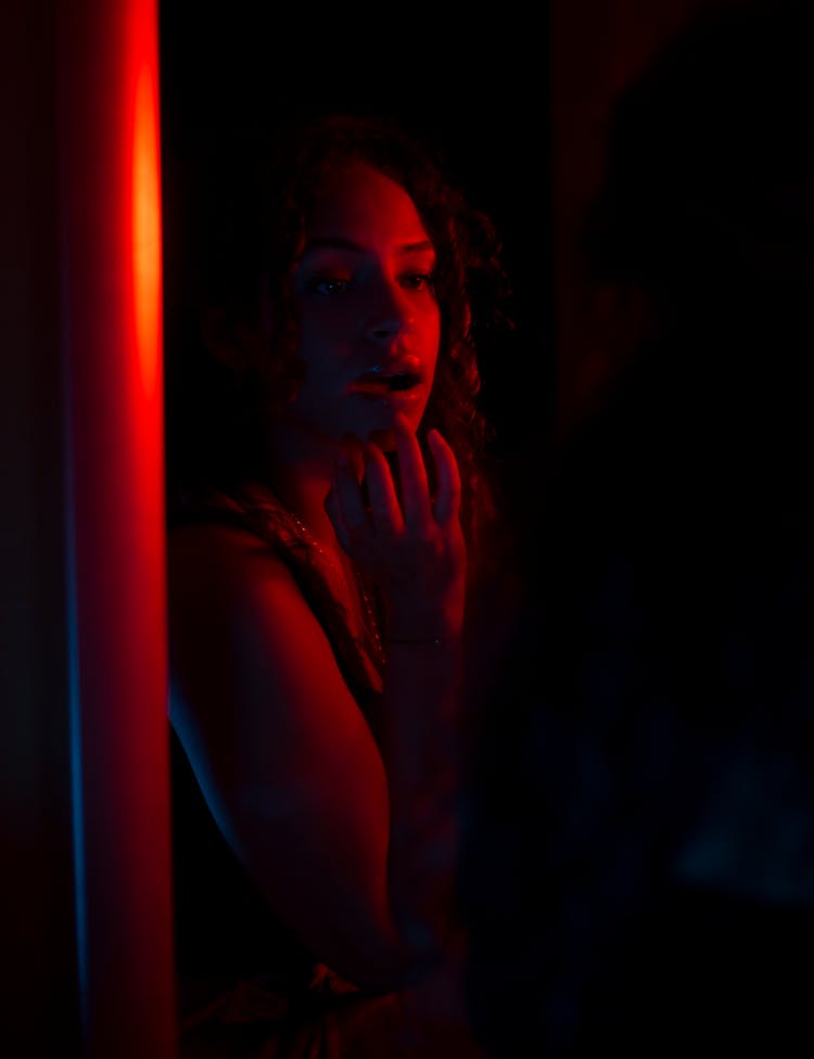 Woman Posing In Red Light In Dark