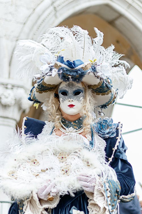 Person Posing in Costume with Mask and Feathers