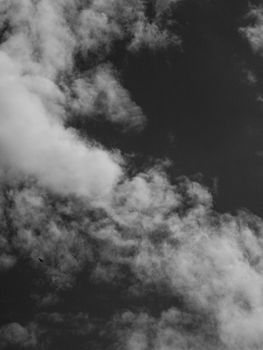 A captivating black and white photograph of dramatic clouds in the sky, showing weather patterns.