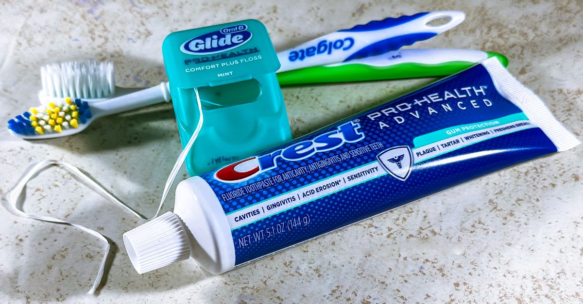 Close-up of dental care items including toothbrush, floss, and toothpaste for oral hygiene. - Evidence evidence guide for green tea oral health randomized trial