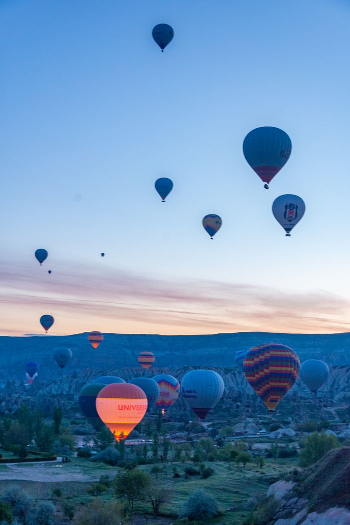 Hot air balloons drifting at sunrise — photo by Diego F. Parra on Pexels