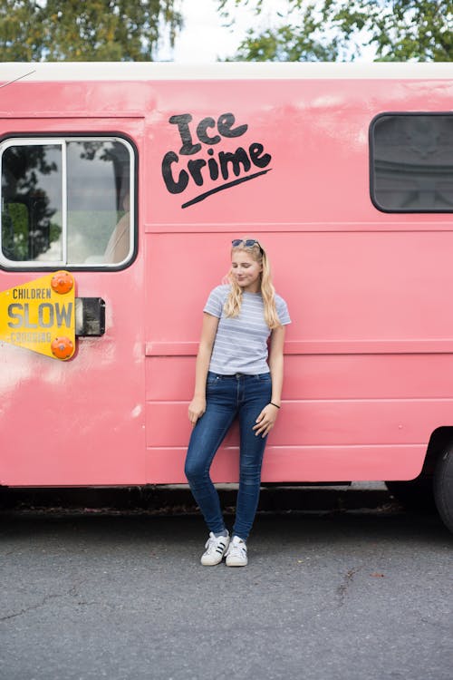 Free Woman Leaning on Pink Vehicle Stock Photo