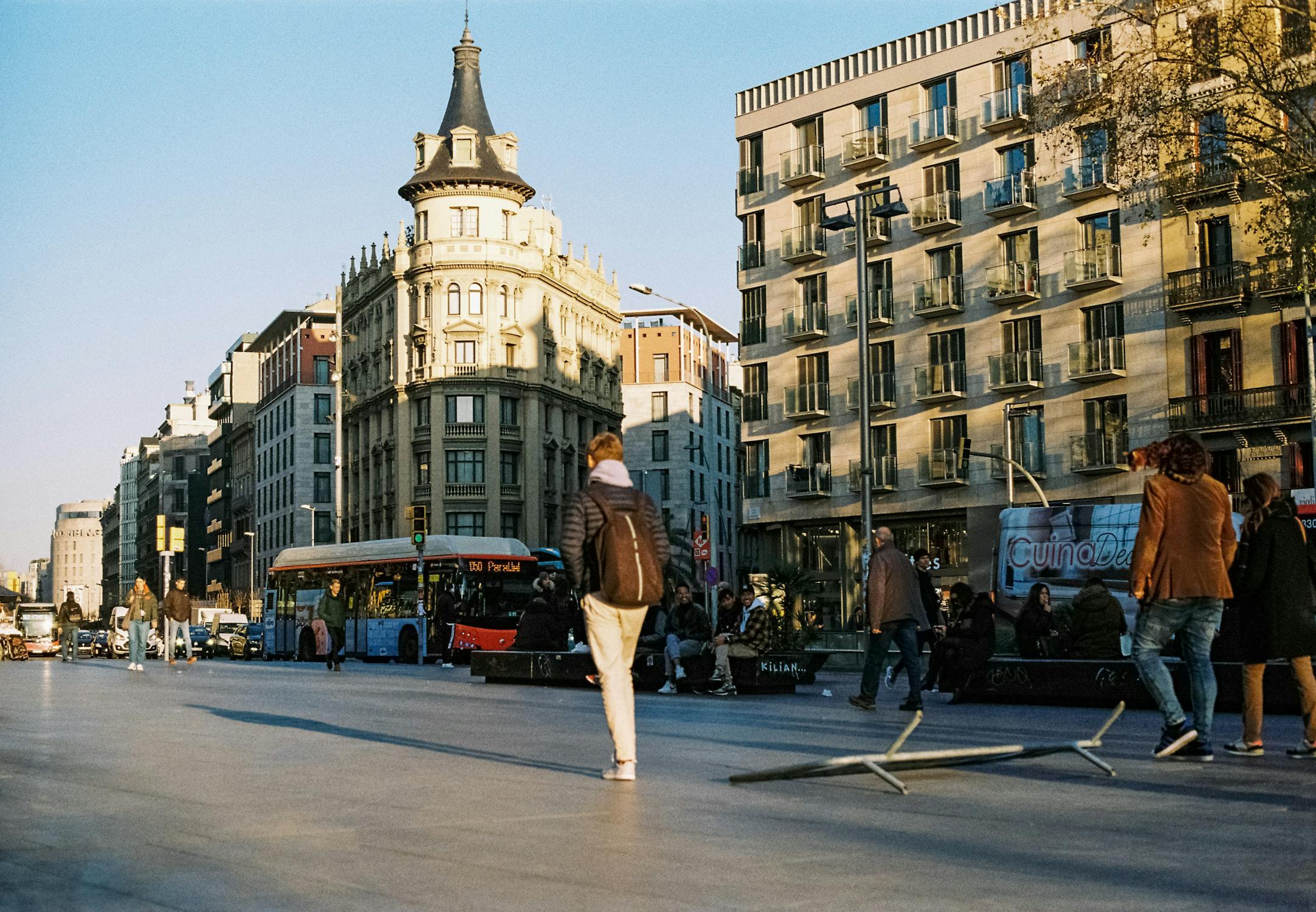Pedestrians Walking on the Street at Sunset in Barcelona Spain