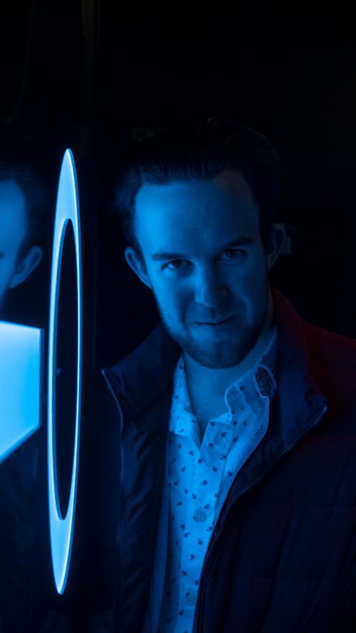 Portrait of a man lit in blue — photo by Paul Rod on Pexels