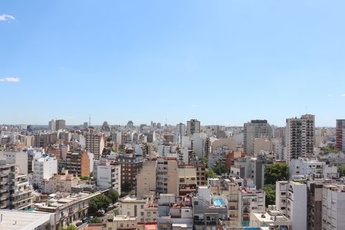 Free Aerial view of Buenos Aires skyline showing a vibrant urban cityscape under a clear blue sky. Stock Photo