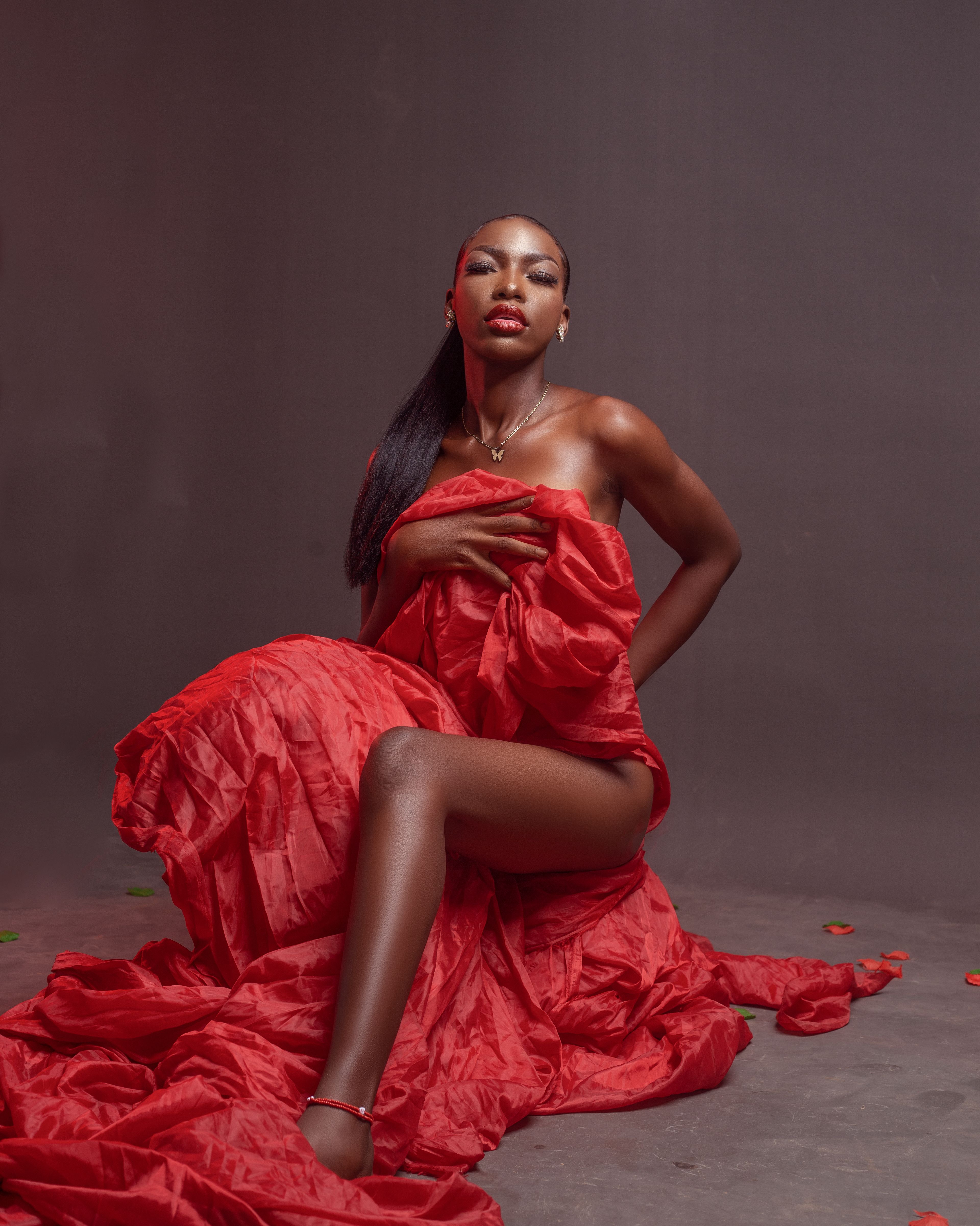 Model Sitting in Red Dress  Free Stock Photo