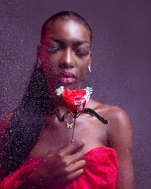 Woman in Red Dress Posing with a Rose