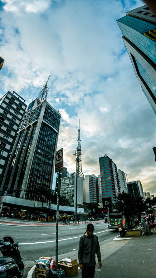Free Dynamic urban scene with modern skyscrapers under a vibrant sky, showcasing urban life. Stock Photo