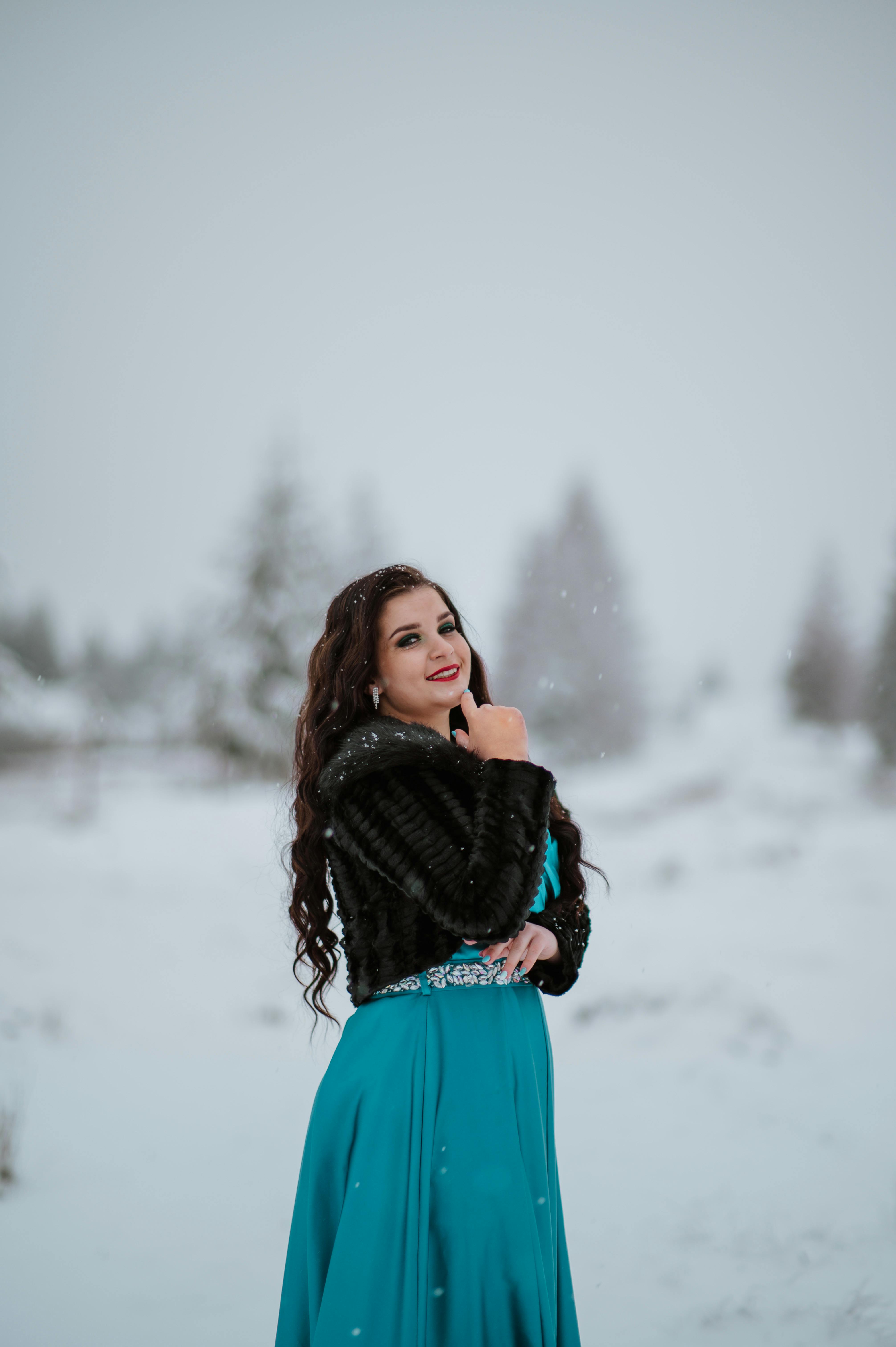 Beautiful Woman Enjoying The Snow In The Park