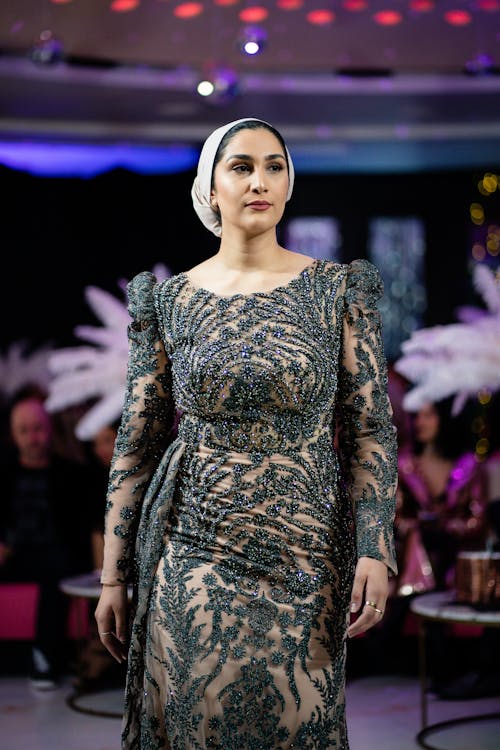 Photo of a Model Wearing an Embroidered Dress on a Fashion Show