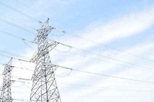 High Voltage Transmission Towers against Blue Sky