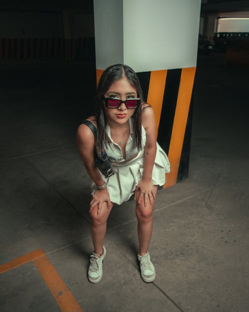 Woman in Red Sunglasses Posing in White Top and Mini Skirt