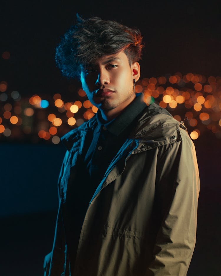 Young Man In A Jacket On The Background Of City Lights At Night 