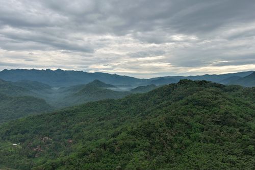 Free Stunning aerial view of misty mountains in Kecamatan Purworejo, Indonesia. Stock Photo