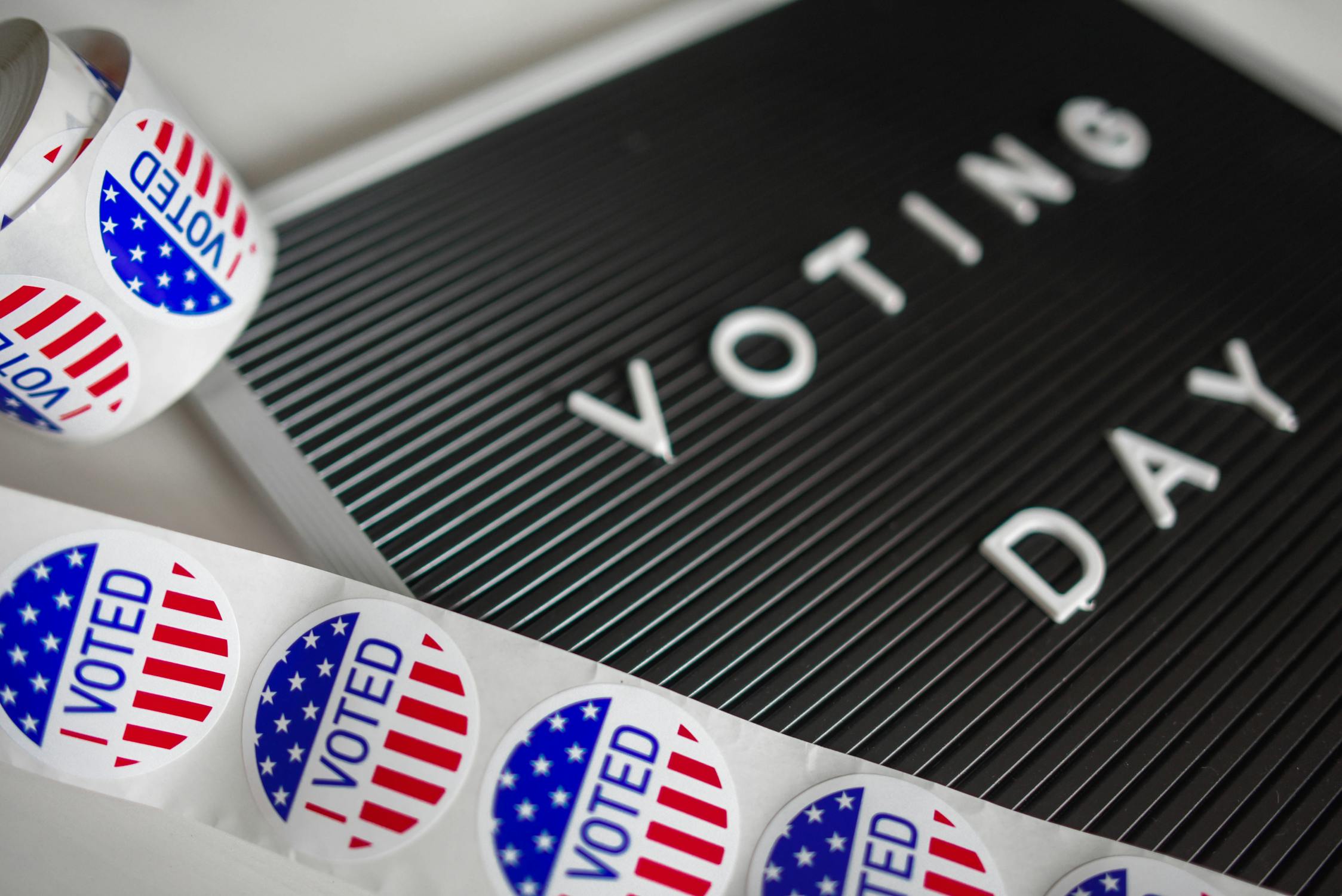 letter board that says voting day and a roll of I voted stickers