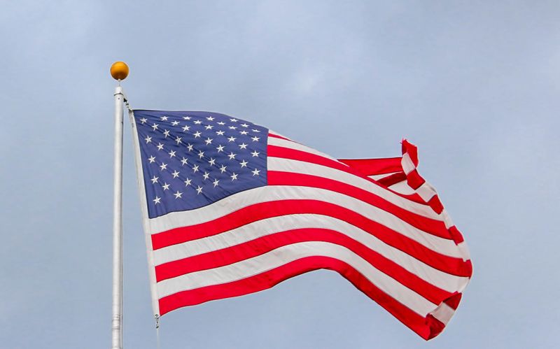 American flag flying proudly representing veteran homeownership and VA loan benefits in San Antonio Texas