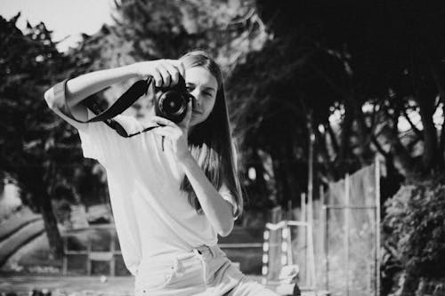 Free Grayscale Photo of Woman Holding Camera Stock Photo
