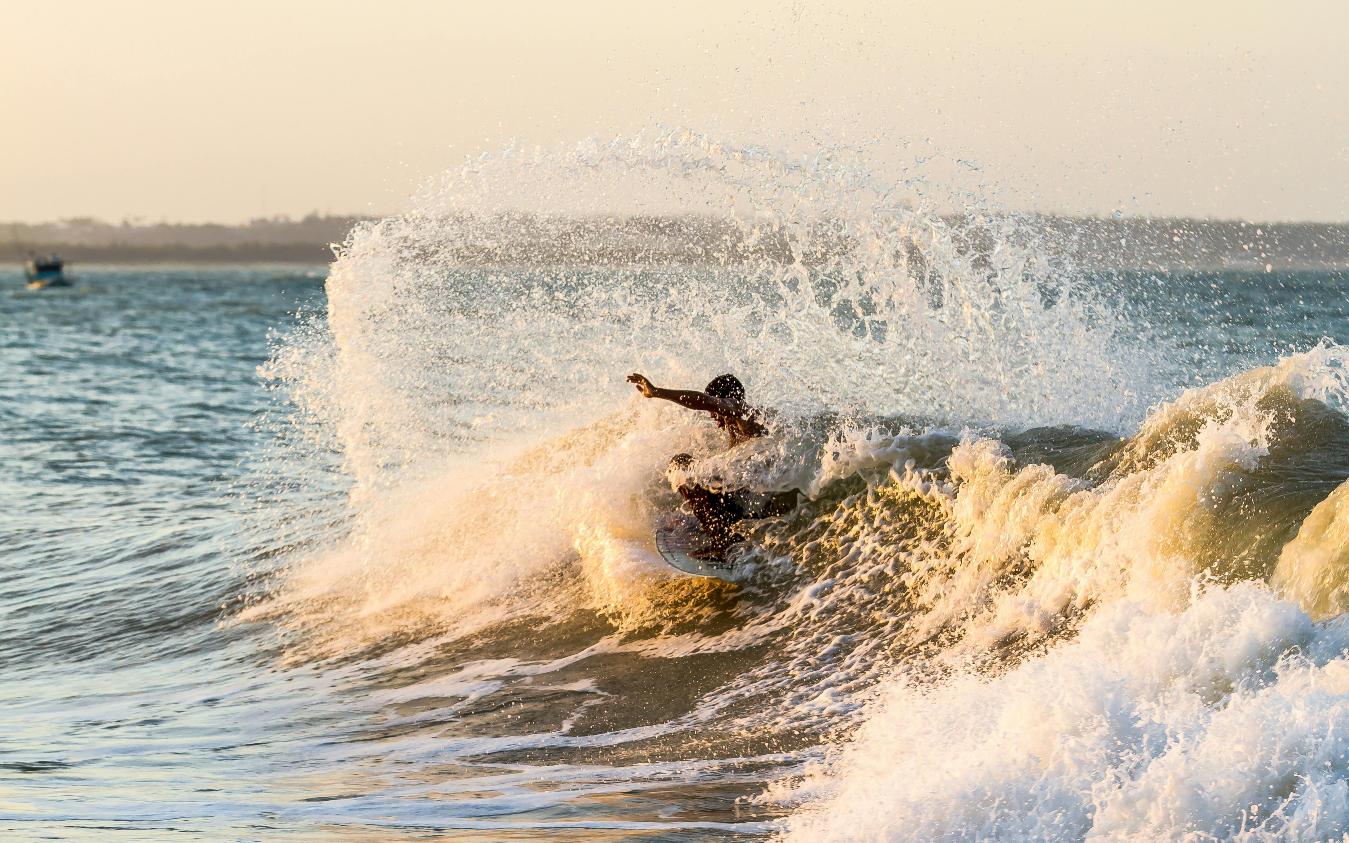 boy surfing sea wave