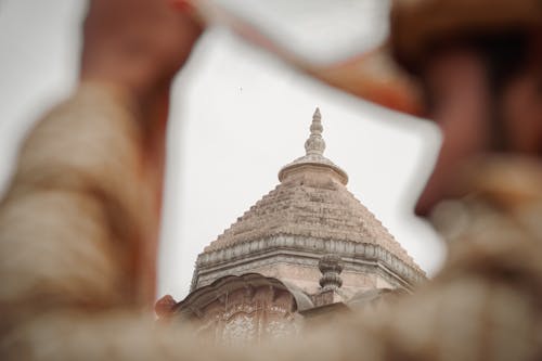 Dome of Buddhist Temple seen behind Persons Shoulder