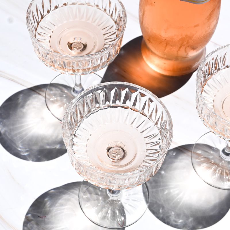 Coupes of rosé sparkling wine seen from above — photo by Studio Naae on Pexels