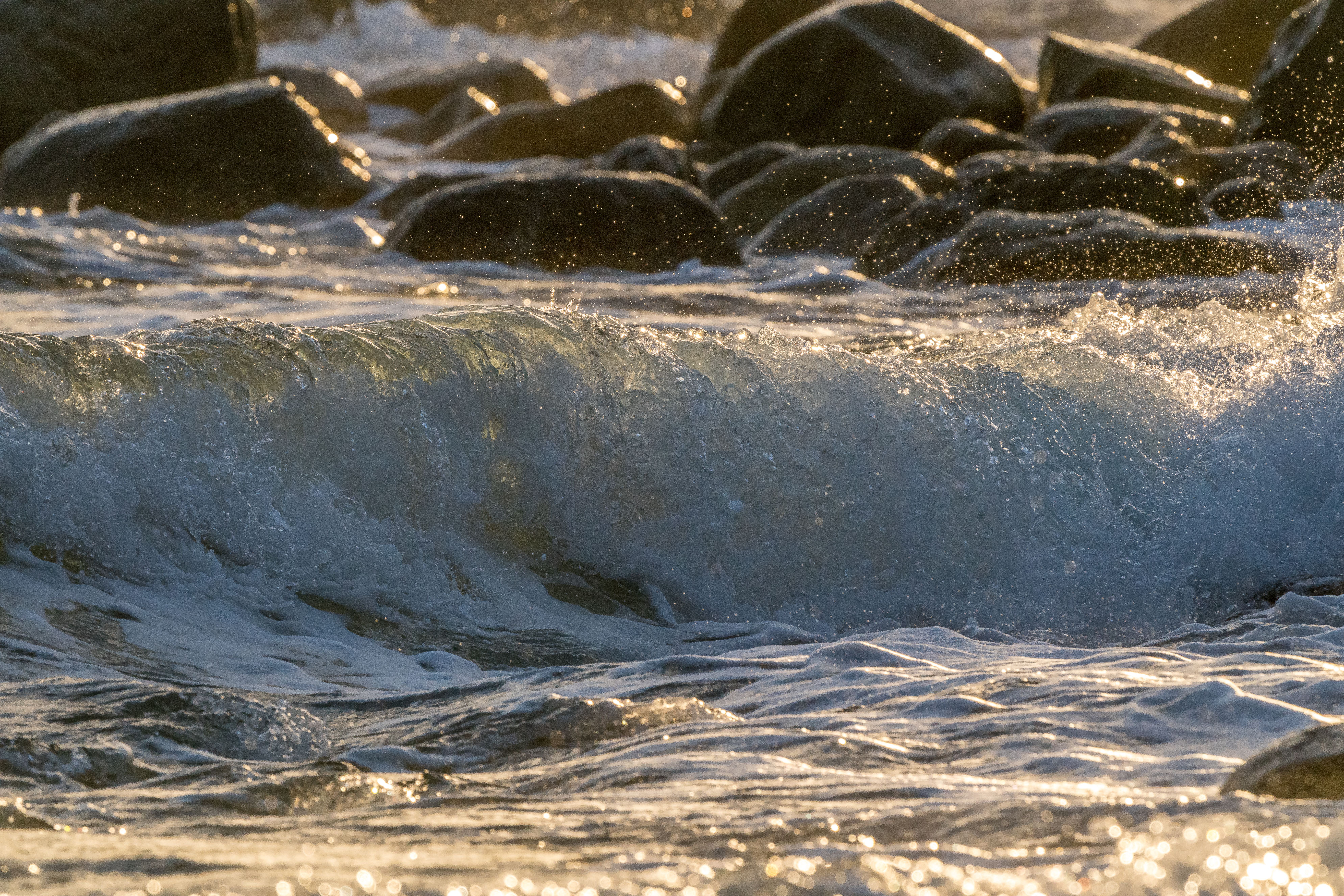 Small Wave Splashing past Coastal Rocks · Free Stock Photo