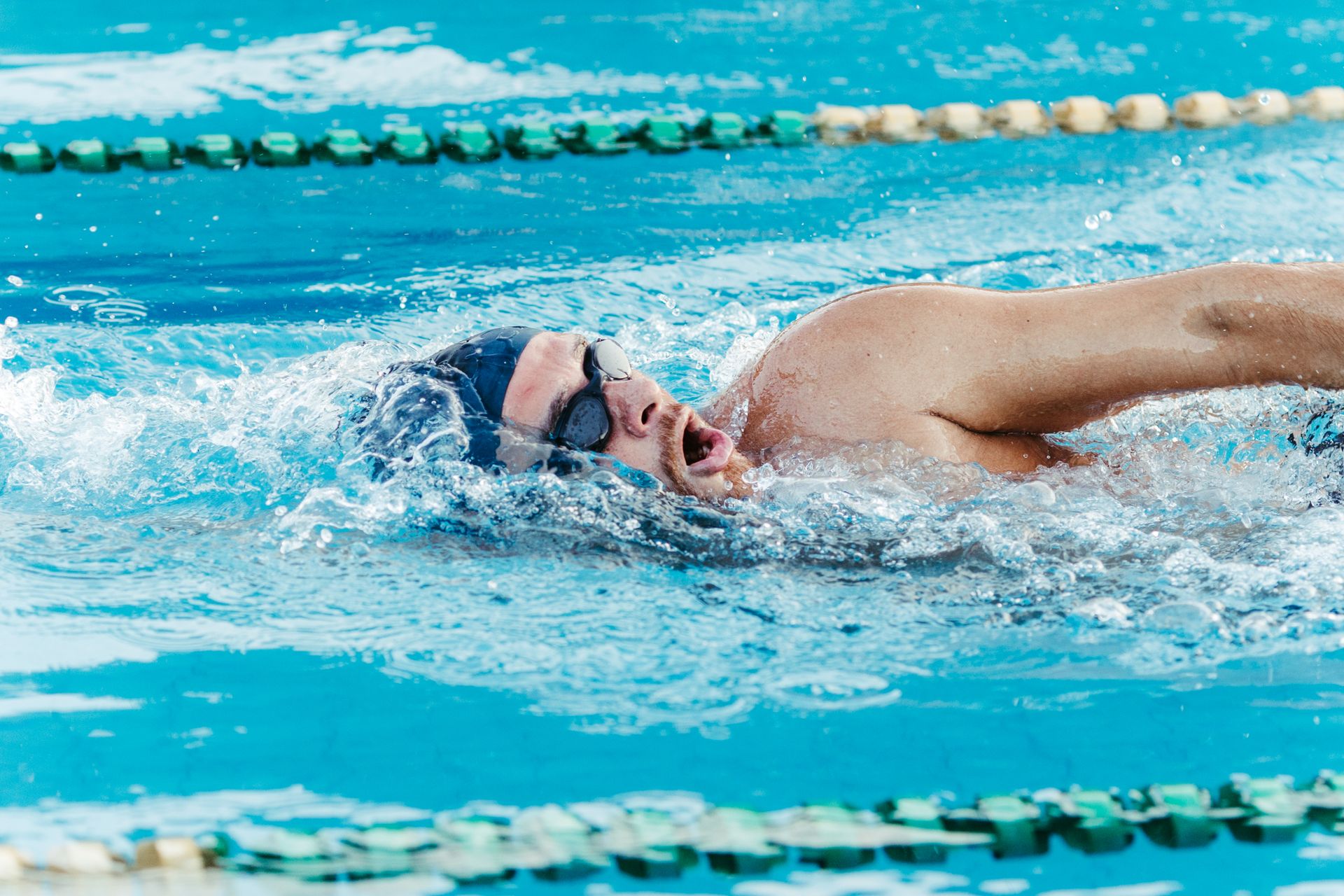 Photo of a Swimmer Swimming in a Pool
