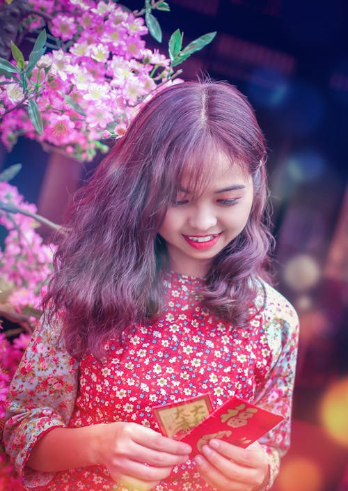 Photo of Woman Holding Red Envelope