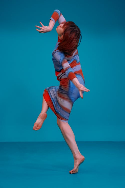 Woman Wearing a Colorful Dress in a Dynamic Pose 