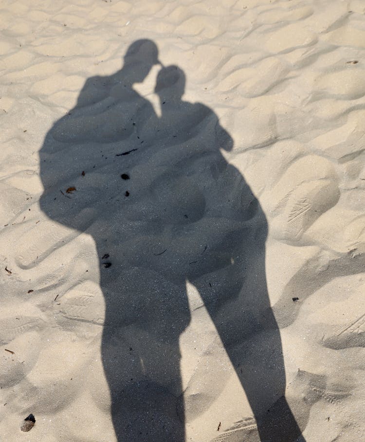 Shadow Of Couple On White Sand