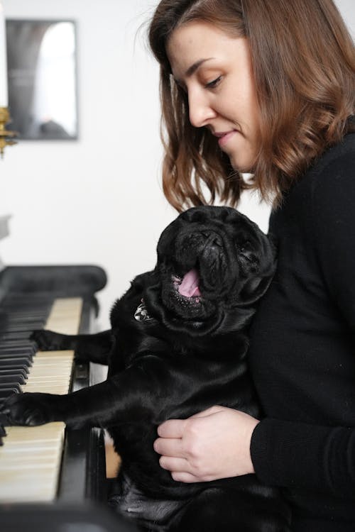 Woman and Cute Dog Playing Piano