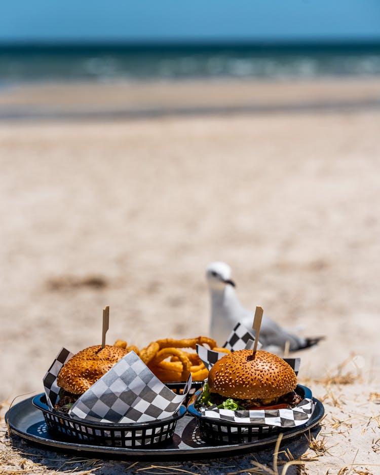 Tray With Two Burgers On A Beach 