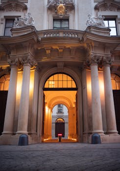 Stunning illuminated entrance of a historical building in Vienna, Austria.
