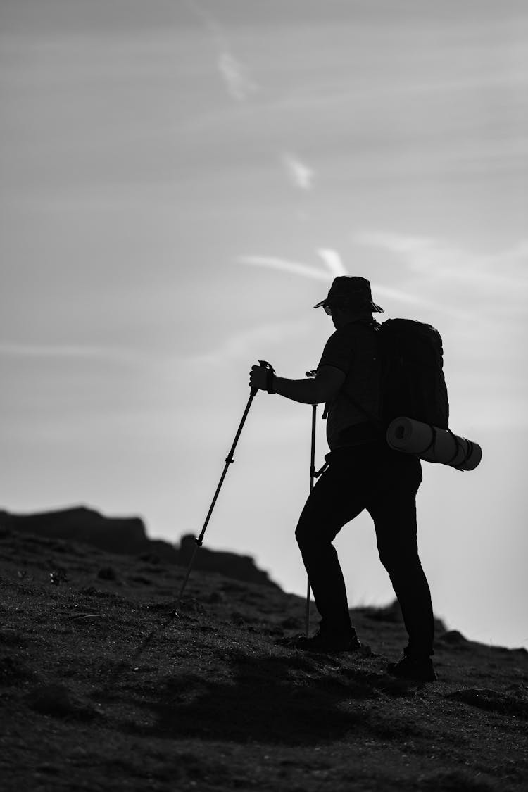 Silhouette Of A Man Hiking 