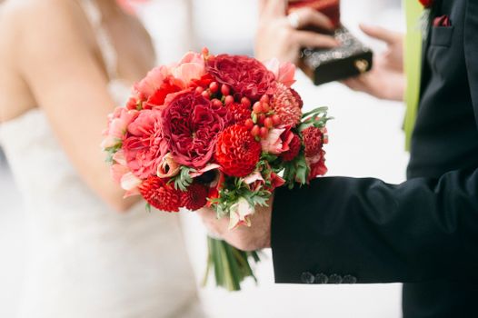 Close-up of a vibrant red floral bouquet, ideal for romantic wedding themes.