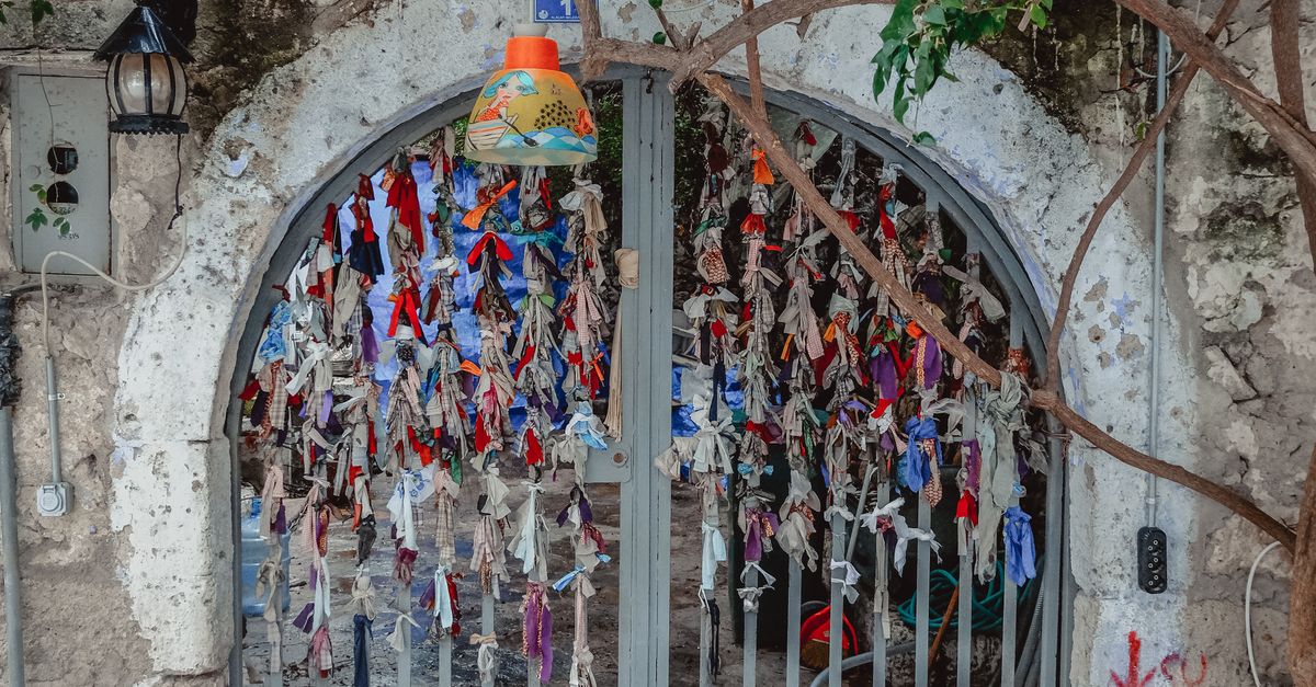 Fabric Strings Hanging on the Gate · Free Stock Photo