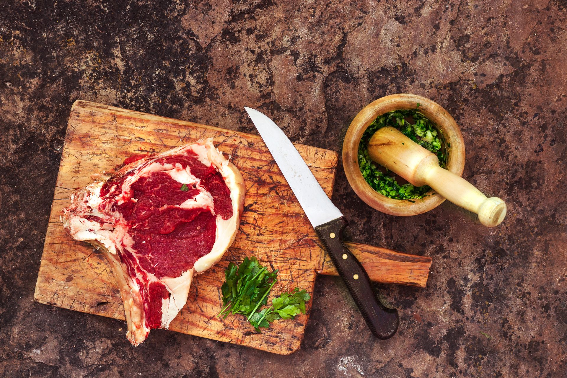 Knife and Beef Steak on Cutting Board