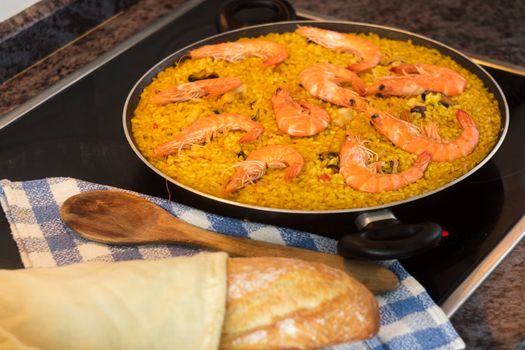 Delicious homemade seafood paella with prawns, cooked on a stovetop, ready to serve.