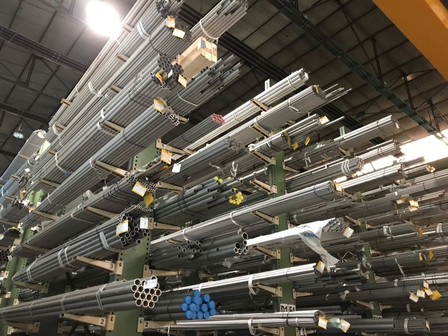galvanized steel pipes stacked in an industrial warehouse