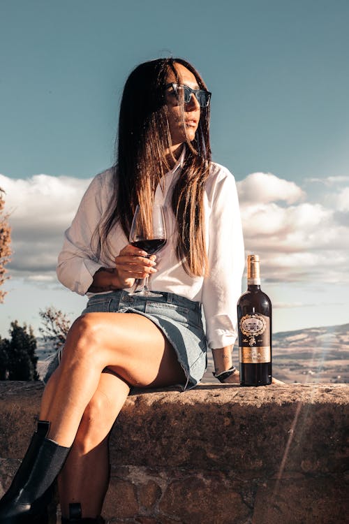 Sitting on Wall Woman Drinking Wine