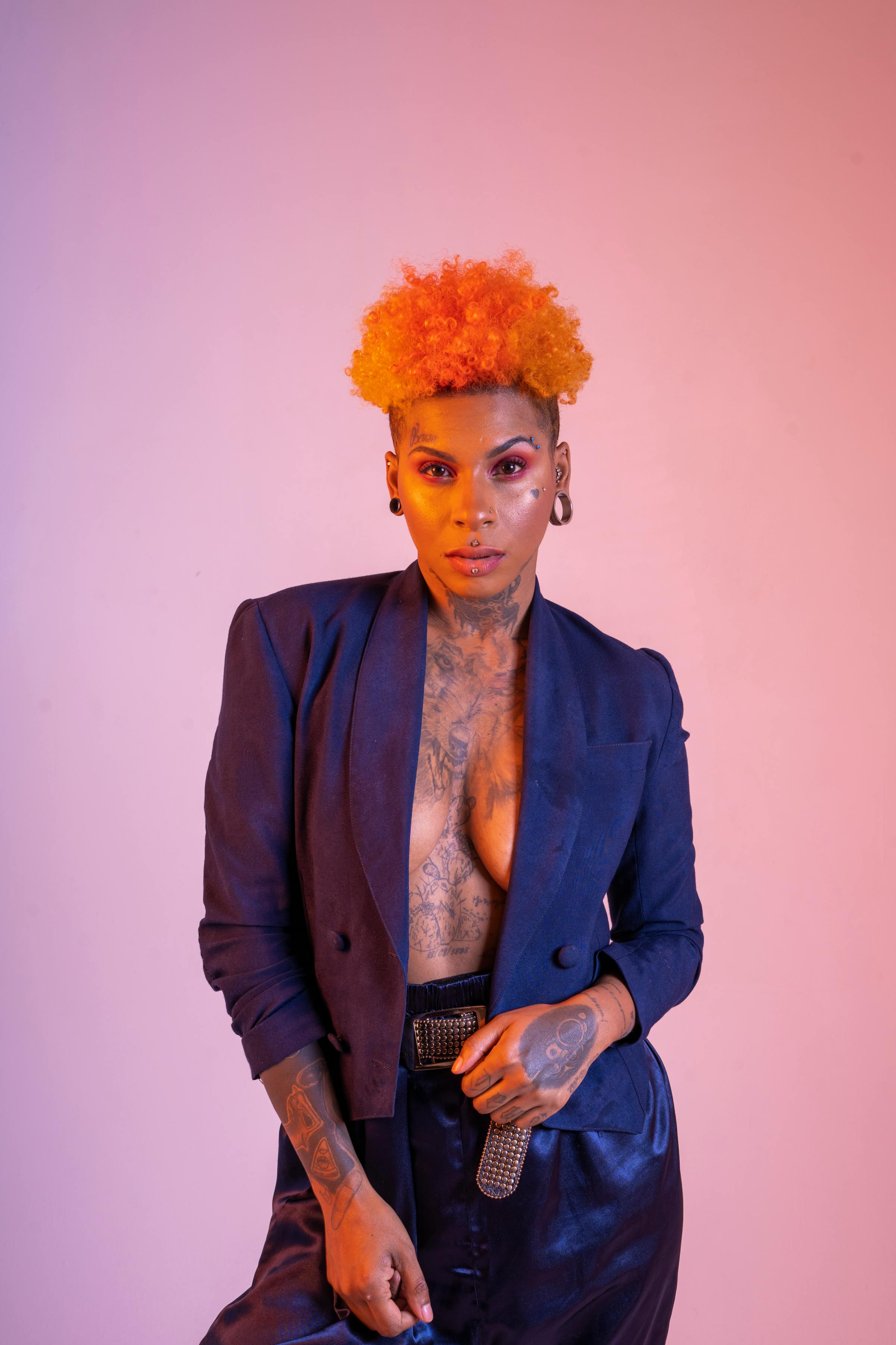 a woman with orange hair and tattoos