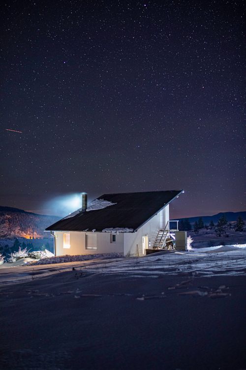 Free Tranquil winter night with a lone house under a clear starry sky in Bosnia. Stock Photo