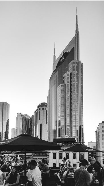 A bustling urban scene with skyscrapers and people in monochrome.