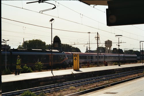 Station Platform and Trains on Tracks