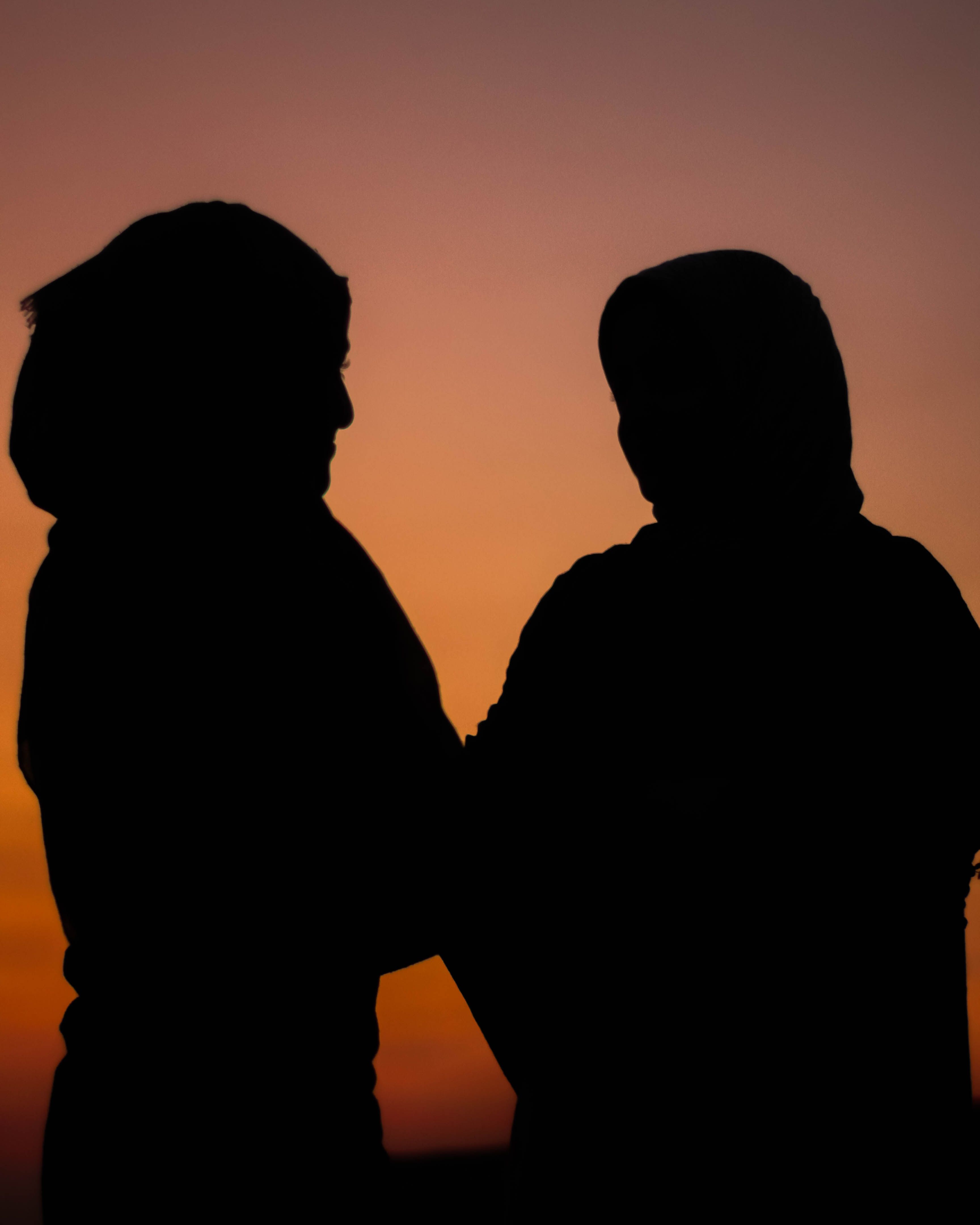 A romantic silhouette of a couple embracing at sunset, highlighting love and companionship.. romantic, silhouette, couple