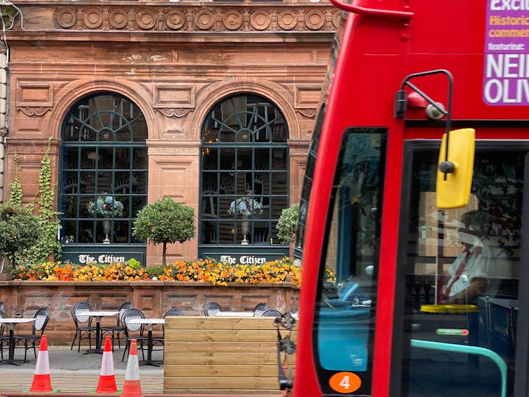 View Of A Red Bus And The Exterior Of A Building At 24 St Vincent Place, Glasgow, Scotland