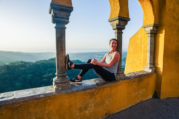 Woman Sitting On Ledge